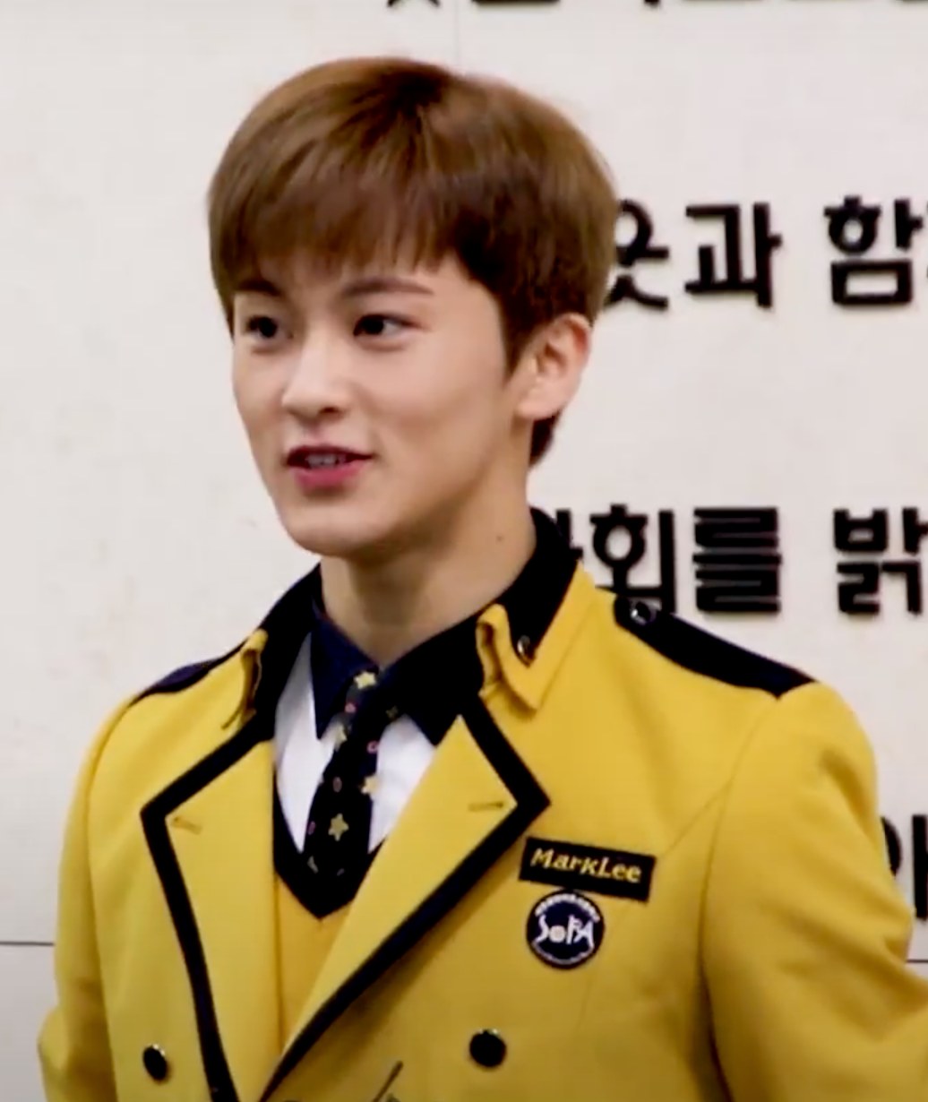 Mark at his 2018 SOPA graduation wearing the yellow school uniform